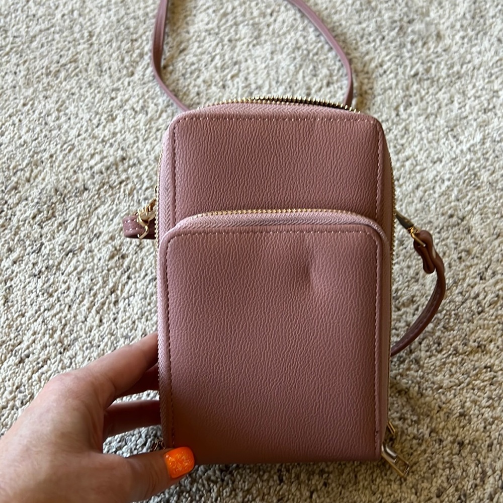 A small, mauve, crossbody bag. Not sure if the brand. It’s never been used.